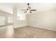 Spacious room featuring neutral paint, tile floors, and a ceiling fan for added comfort at 21840 N 41St St, Phoenix, AZ 85050