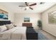 Comfortable bedroom with a ceiling fan, a dark wood dresser, and a blue rug at 21840 N 41St St, Phoenix, AZ 85050