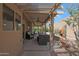 The back porch offers an ideal place to relax, with overhead lighting and comfortable seating, perfect for outdoor enjoyment at 25639 S Beech Creek Dr, Sun Lakes, AZ 85248