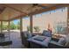 Relaxing backyard featuring seating area, a charming fireplace, lush greenery, and mature trees offering a tranquil outdoor space at 25639 S Beech Creek Dr, Sun Lakes, AZ 85248