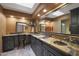 Elegant bathroom with dual sinks, granite countertops, and decorative wall features at 25639 S Beech Creek Dr, Sun Lakes, AZ 85248