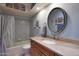 Bathroom with decorative mirror, granite counters and shower with curtain at 25639 S Beech Creek Dr, Sun Lakes, AZ 85248