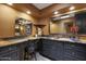 Bathroom boasts a vanity, framed mirrors and a warm earth tone paint at 25639 S Beech Creek Dr, Sun Lakes, AZ 85248
