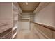 A large walk-in closet with custom shelving and hanging racks at 25639 S Beech Creek Dr, Sun Lakes, AZ 85248