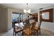 Bright dining room featuring a glass table and backyard patio access for indoor/outdoor living at 25639 S Beech Creek Dr, Sun Lakes, AZ 85248