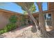 Charming front entrance featuring a brick walkway, xeriscaping, and a cozy, shaded seating nook at 25639 S Beech Creek Dr, Sun Lakes, AZ 85248