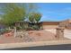 Single-story home with low-maintenance desert landscaping, complemented by native trees and a two-car garage at 25639 S Beech Creek Dr, Sun Lakes, AZ 85248