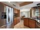 Bright kitchen with stainless steel refrigerator and tile floors overlooking a dining area at 25639 S Beech Creek Dr, Sun Lakes, AZ 85248