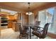 Eat-in kitchen featuring a glass top table, stainless steel appliances, and natural wood cabinets at 25639 S Beech Creek Dr, Sun Lakes, AZ 85248