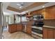 Well-equipped kitchen featuring stainless steel appliances, wood cabinets, and neutral countertops at 25639 S Beech Creek Dr, Sun Lakes, AZ 85248