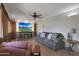 Inviting living room with comfortable seating, tile flooring, and entertainment center with fireplace at 25639 S Beech Creek Dr, Sun Lakes, AZ 85248