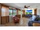 Bright living room featuring neutral tones, tile floors, large windows, and fireplace at 25639 S Beech Creek Dr, Sun Lakes, AZ 85248