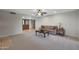 Inviting living room featuring neutral carpet and view of front entry with double doors at 25639 S Beech Creek Dr, Sun Lakes, AZ 85248