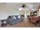 Open-concept living room with comfortable seating, neutral color palette, and easy access to other areas at 25639 S Beech Creek Dr, Sun Lakes, AZ 85248