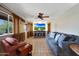 Living area with neutral tones, tile floors, fireplace, and large windows at 25639 S Beech Creek Dr, Sun Lakes, AZ 85248