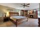 This main bedroom has a ceiling fan, fireplace and access to storage at 25639 S Beech Creek Dr, Sun Lakes, AZ 85248