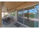 Covered patio area with outdoor dining set and view of landscaped backyard at 25639 S Beech Creek Dr, Sun Lakes, AZ 85248