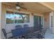 Covered patio area with outdoor dining set and ceiling fan at 25639 S Beech Creek Dr, Sun Lakes, AZ 85248