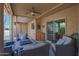 Inviting covered patio featuring comfortable seating, a ceiling fan, and a tiled fire pit table perfect for outdoor relaxation at 25639 S Beech Creek Dr, Sun Lakes, AZ 85248