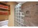 The shower features travertine tile and a sleek glass block wall at 25639 S Beech Creek Dr, Sun Lakes, AZ 85248