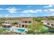 Aerial view of the backyard oasis with a pool, spa, outdoor kitchen, basketball court, and trampoline at 30129 N 52Nd Pl, Cave Creek, AZ 85331