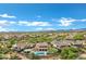 A high altitude aerial shot showcases the home's backyard pool and spa, covered patio, and neighborhood at 30129 N 52Nd Pl, Cave Creek, AZ 85331