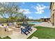 Expansive backyard with a pool, firepit, and outdoor kitchen, designed for outdoor living and entertaining at 30129 N 52Nd Pl, Cave Creek, AZ 85331