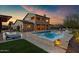 Beautiful backyard oasis featuring a pool, spa, outdoor kitchen, and covered patio area at 30129 N 52Nd Pl, Cave Creek, AZ 85331