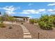 Beautiful backyard featuring a built-in outdoor kitchen and bar area, surrounded by lush landscaping at 30129 N 52Nd Pl, Cave Creek, AZ 85331