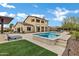 Expansive backyard with a pool, spa, covered patio, and lush landscaping, creating a perfect outdoor retreat at 30129 N 52Nd Pl, Cave Creek, AZ 85331