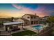 Stunning backyard with a large pool, spa, outdoor kitchen, fire pit and desert views at sunset at 30129 N 52Nd Pl, Cave Creek, AZ 85331
