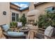 Cozy courtyard featuring a fireplace, outdoor seating, and garden views, perfect for relaxation at 30129 N 52Nd Pl, Cave Creek, AZ 85331