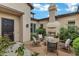 Charming courtyard with a fireplace, comfortable seating, and lush greenery, creating a relaxing outdoor space at 30129 N 52Nd Pl, Cave Creek, AZ 85331