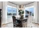 Bright dining room with large windows, decorative chandelier, and dark wood dining table creating a cozy atmosphere at 30129 N 52Nd Pl, Cave Creek, AZ 85331