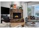 Close-up of the living room's stone fireplace and comfortable seating, enhancing the cozy ambiance at 30129 N 52Nd Pl, Cave Creek, AZ 85331