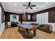 Spacious game room with a billiard table, hardwood floors, and comfortable leather seating at 30129 N 52Nd Pl, Cave Creek, AZ 85331