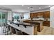 Spacious kitchen featuring a breakfast bar, stainless steel appliances, granite countertops, and ample natural light at 30129 N 52Nd Pl, Cave Creek, AZ 85331