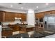 Beautiful kitchen with granite countertops, wood cabinets, stainless steel appliances, and a functional center island at 30129 N 52Nd Pl, Cave Creek, AZ 85331