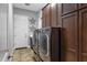 Well-equipped laundry room with modern washer and dryer, custom cabinetry, and neutral tile floors at 30129 N 52Nd Pl, Cave Creek, AZ 85331