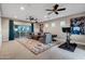 Spacious living room with a modern decor, large windows, stylish rug, and exercise equipment at 30129 N 52Nd Pl, Cave Creek, AZ 85331