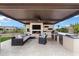 Outdoor living area featuring a fireplace, grill, and ample seating at 30129 N 52Nd Pl, Cave Creek, AZ 85331