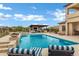 Backyard pool area with lounge chairs, spa, and outdoor kitchen at 30129 N 52Nd Pl, Cave Creek, AZ 85331
