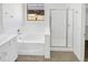 Serene bathroom featuring a separate shower and soaking tub, complemented by modern fixtures and ample counter space at 3013 S 102Nd Ln, Tolleson, AZ 85353