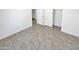 This bedroom features neutral paint and tile, with a door to a closet and additional rooms at 3013 S 102Nd Ln, Tolleson, AZ 85353