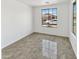 This bedroom boasts natural light and neutral walls with tile flooring, perfect for personalization at 3013 S 102Nd Ln, Tolleson, AZ 85353
