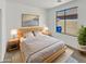 Cozy bedroom with natural light, a comfortable bed, and minimalist decor for restful nights at 3013 S 102Nd Ln, Tolleson, AZ 85353