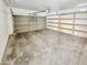 Empty garage with built-in shelving, ready for storage at 3013 S 102Nd Ln, Tolleson, AZ 85353