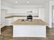 Spacious kitchen with white cabinets, a large center island, and stainless steel appliances at 3013 S 102Nd Ln, Tolleson, AZ 85353