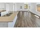 Bright kitchen and living space with modern wood-look tile floors and lots of natural light at 3013 S 102Nd Ln, Tolleson, AZ 85353