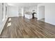 Spacious, light-filled living area with open layout, wood-look tile flooring and bright white paint at 3013 S 102Nd Ln, Tolleson, AZ 85353